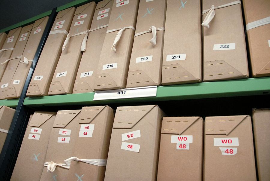 Rows of gray document boxes on repository shelving at The National Archives in Kew