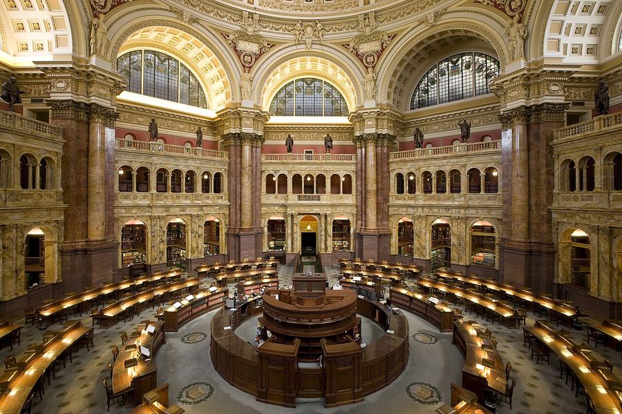 The domed Main Reading Room of the Library of Congress, with circular desks below marble arches